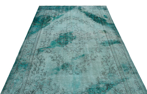 Load image 1 in gallery view. Distressed teal and grey vintage-style rug with a central floral medallion and ornate border on a white background.