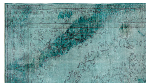 Load image 1 in gallery view. Teal and dark grey distressed rug with a faded floral medallion pattern and a thin border.