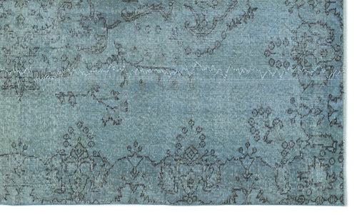 Load image 1 in gallery view. Distressed light blue rug with a dark grey traditional floral medallion pattern and visible stitched seam detail.