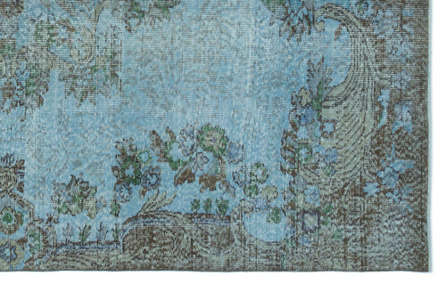 Load image 1 in gallery view. Distressed light blue rug with a dark brown floral border and faded botanical motifs.