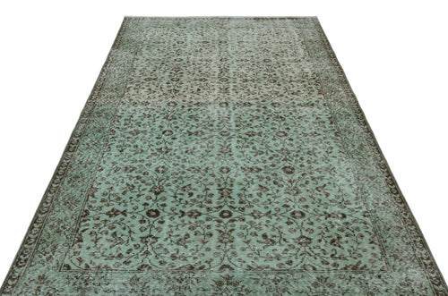 Load image 1 in gallery view. Sage green and brown vintage-style rug with a distressed floral vine pattern and a decorative border.