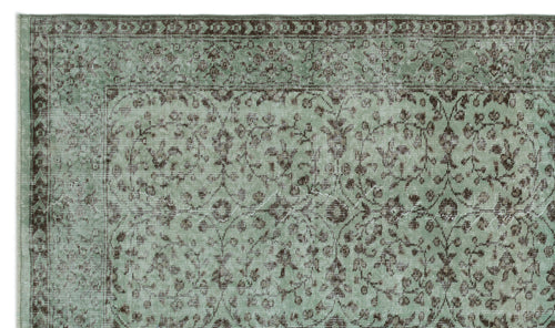 Load image 1 in gallery view. Sage green and brown distressed rug with a traditional floral vine pattern and a decorative border.