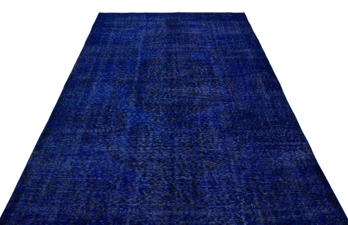 Deep blue vintage-style rug with a distressed, faded traditional pattern on a white background.