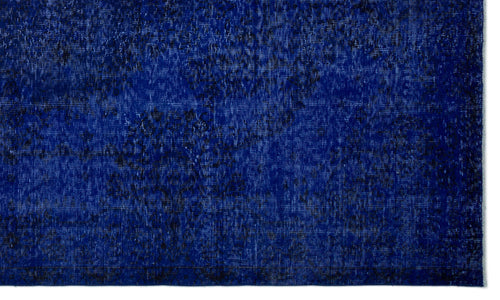 Load image 1 in gallery view. Deep blue rug with a distressed, mottled texture and subtle black vintage-style pattern.