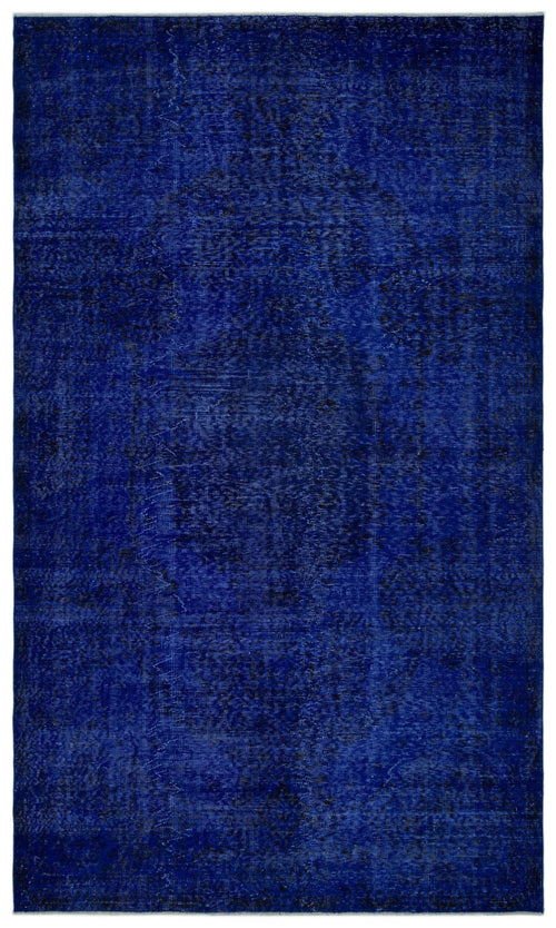 Load image 1 in gallery view. Deep blue distressed rug with a faint, traditional central medallion pattern on a white background.