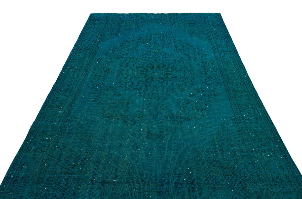 Teal distressed rug with a traditional central medallion and ornate border pattern on a white background.