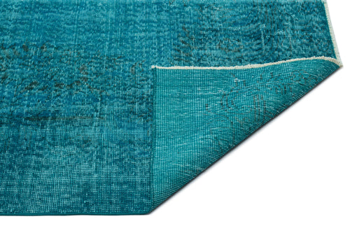 Load image 1 in gallery view. Teal distressed-style rug with a folded corner revealing the woven backing and fringe edge on a white background.