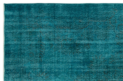 Load image 1 in gallery view. Teal distressed rug with a faded, horizontal linear texture and subtle dark charcoal vintage-style motifs.