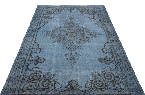 Load image 1 in gallery view. Distressed blue rug with a dark brown traditional floral medallion and border pattern on a white background.
