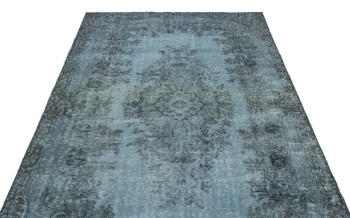 Load image 1 in gallery view. Distressed blue and charcoal area rug with a traditional central medallion and floral border pattern.