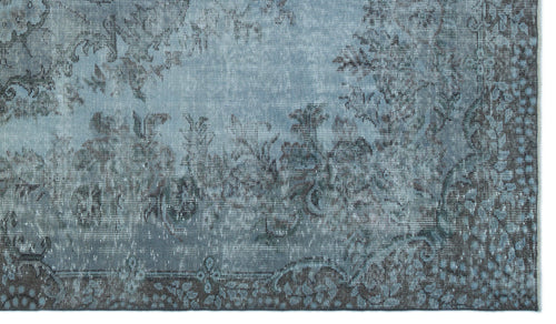 Load image 1 in gallery view. Blue and charcoal grey rug with a distressed, traditional floral medallion pattern.