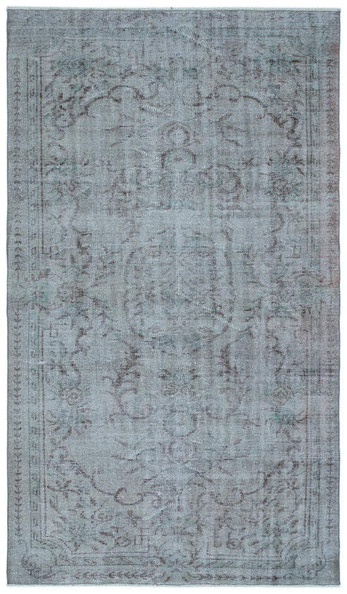Load image 1 in gallery view. Faded blue and grey distressed rug with a traditional central medallion and ornate floral border.