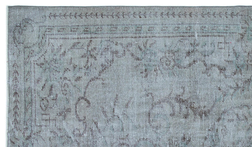 Load image 1 in gallery view. Distressed light blue and grey rug with a faded traditional floral medallion pattern and a geometric border.