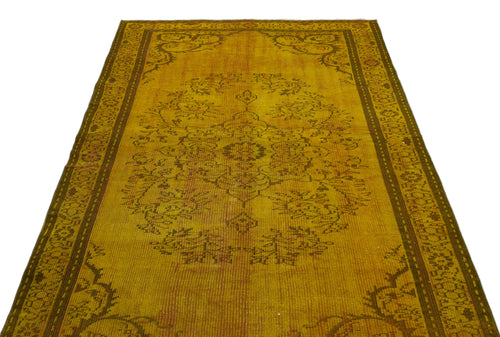 Load image 1 in gallery view. Mustard yellow distressed rug with a dark brown central floral medallion and ornate border on a white background.