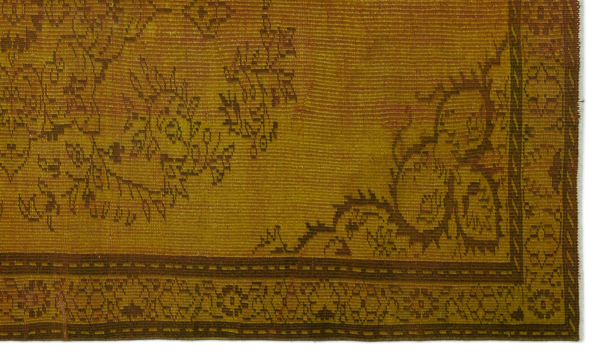Mustard yellow vintage rug with a dark brown floral border and distressed traditional pattern.