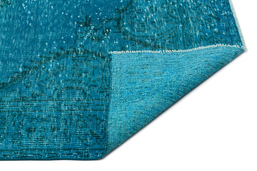 Load image 1 in gallery view. Teal distressed rug with a faded traditional medallion pattern, shown with a corner folded over to reveal the backing.