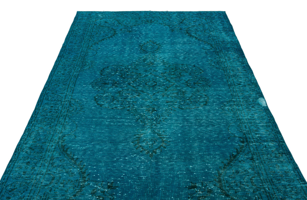 Teal distressed rug with a faded traditional medallion pattern on a white background.