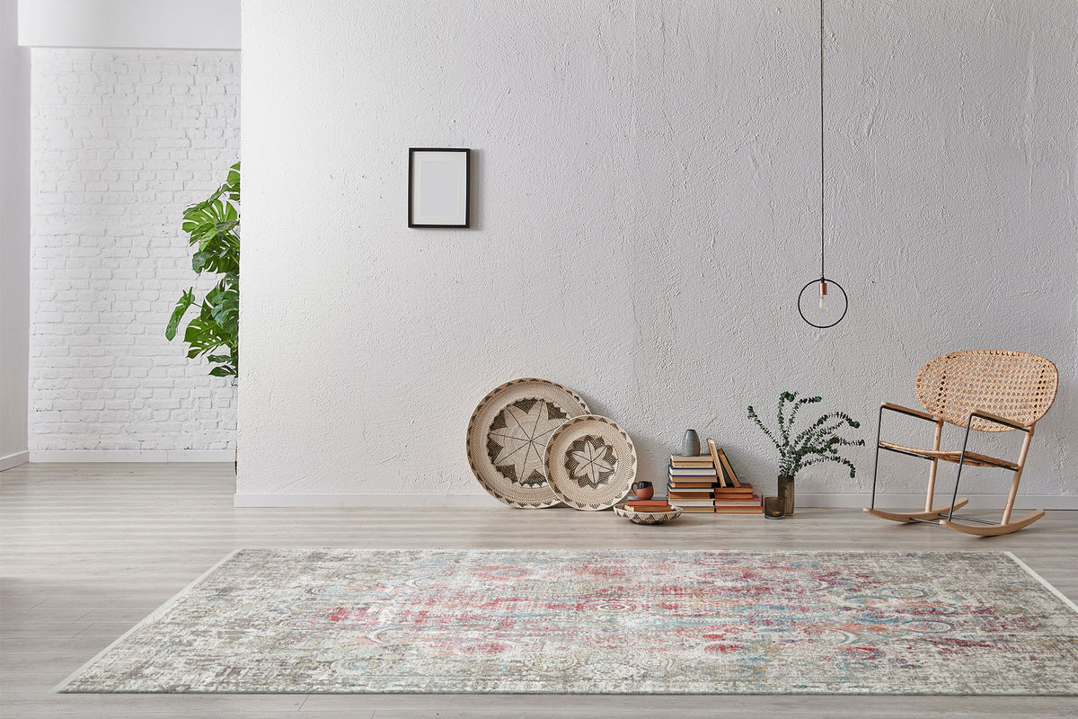 Distressed multi-colored medallion rug with red and blue accents, styled in a minimalist living room.