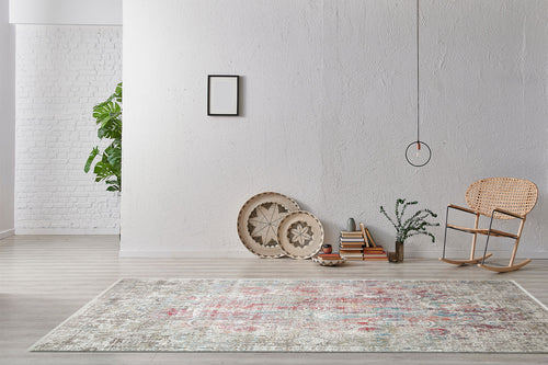 Bild 1 in Galerieansicht laden. Distressed multi-colored medallion rug with red and blue accents, styled in a minimalist living room.