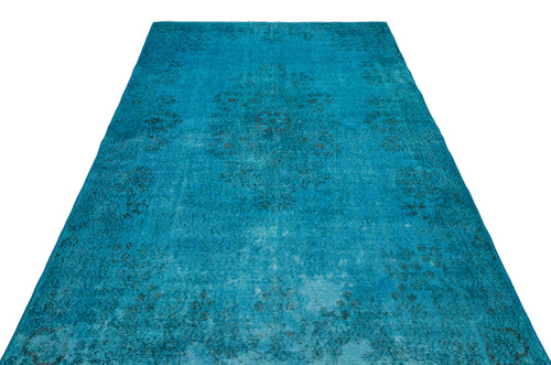 Load image 1 in gallery view. Bright turquoise distressed rug with a faint, dark floral medallion pattern.