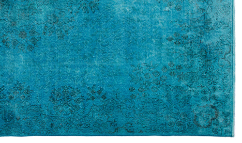 Load image 1 in gallery view. Bright turquoise rug with a distressed, faded floral medallion pattern.