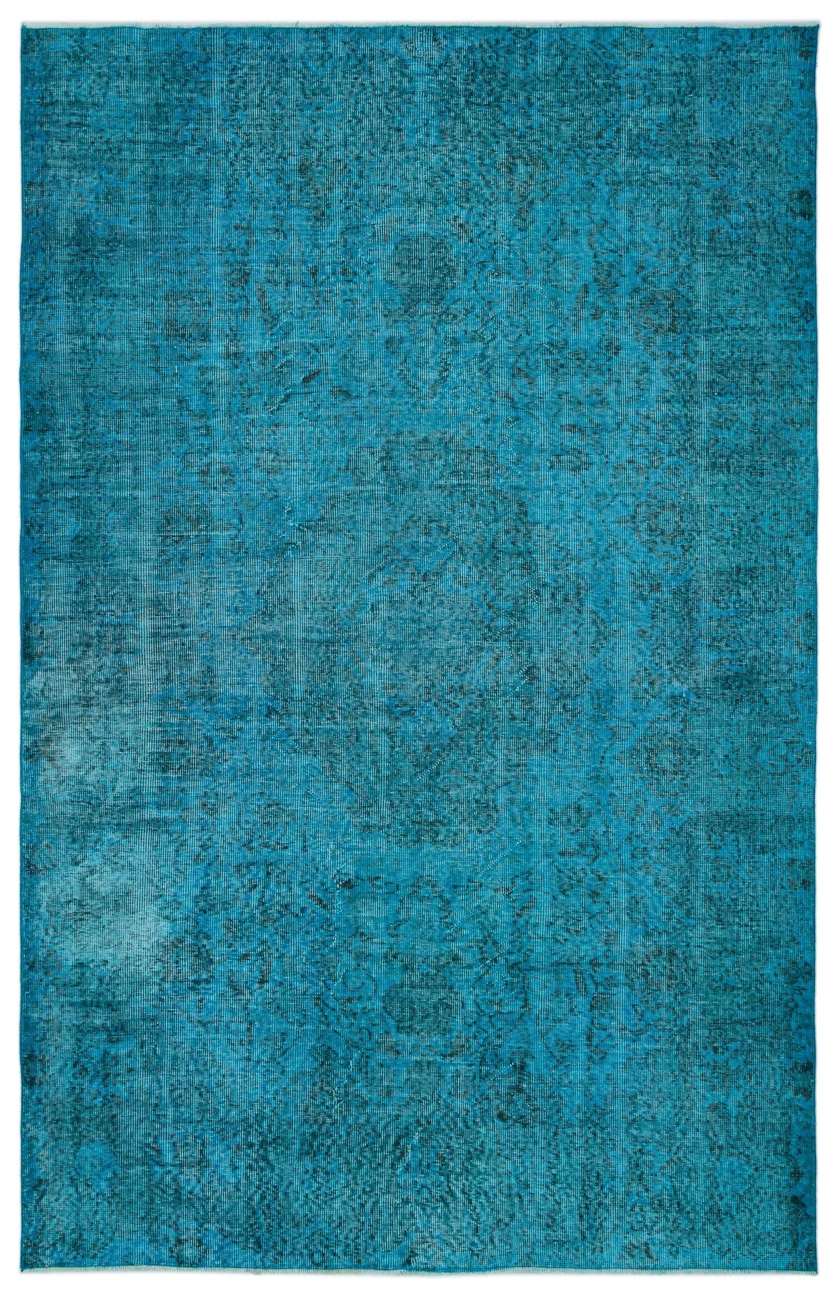 Teal distressed area rug with a faint, traditional medallion pattern.