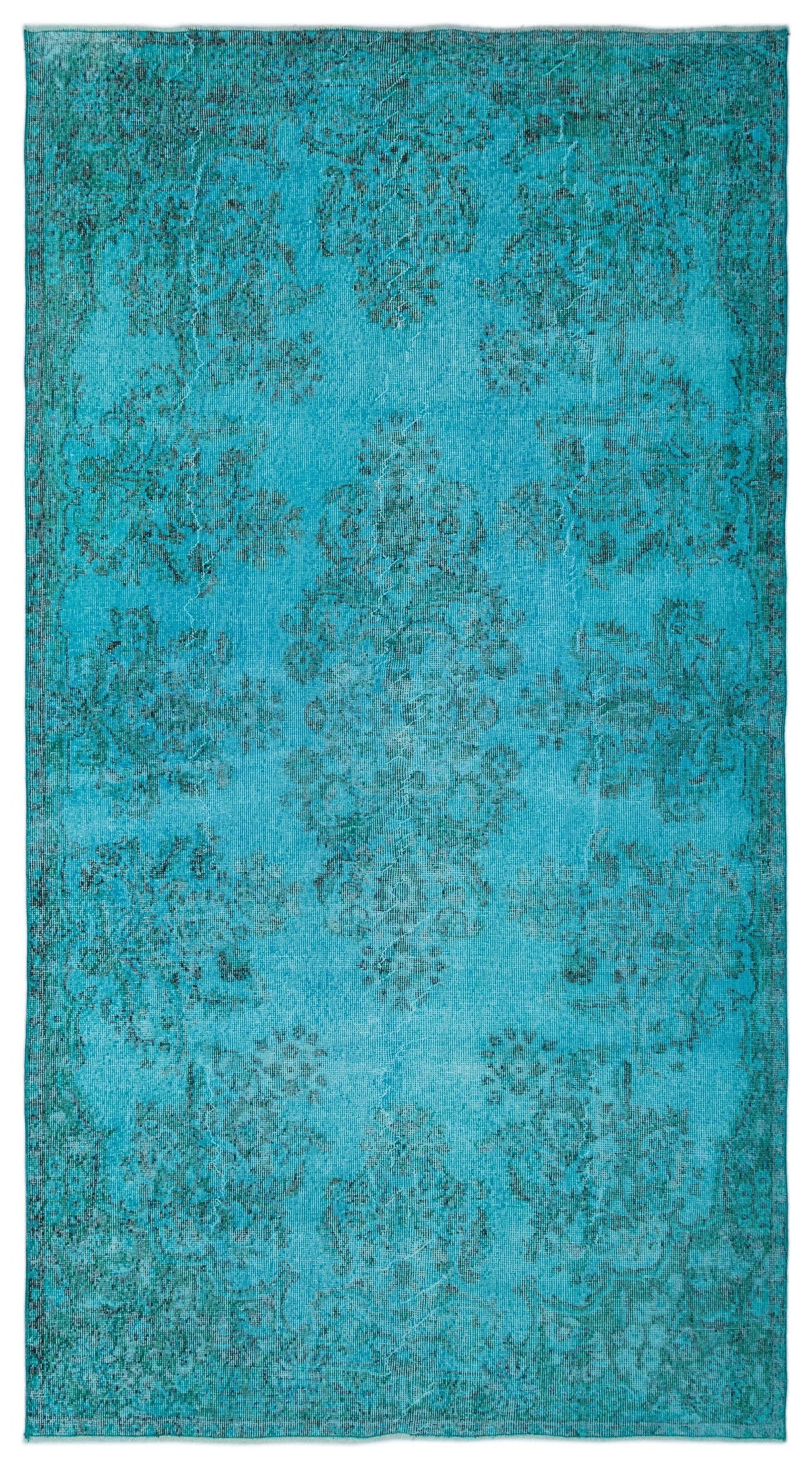 Bright turquoise distressed rug with a dark teal traditional floral medallion pattern.