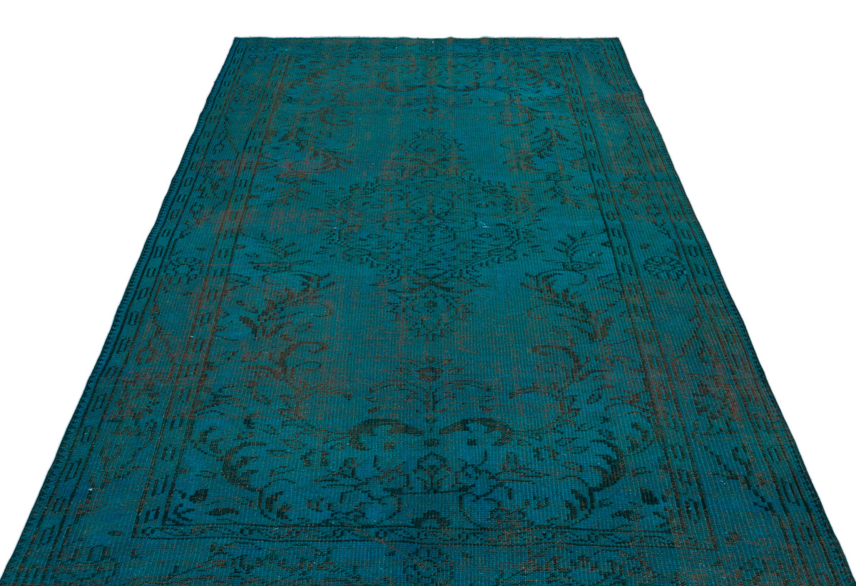 Teal and dark brown vintage-style rug with a central medallion and ornate floral border on a white background.