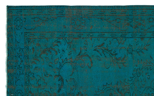 Load image 1 in gallery view. Teal rug with a dark brown distressed floral pattern and a geometric border.
