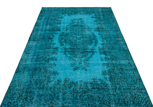 Load image 1 in gallery view. Distressed turquoise rug with a dark blue central floral medallion and ornate border pattern on a white background.