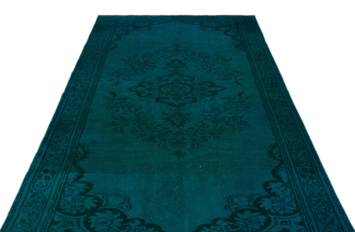 Teal and black traditional rug with a central floral medallion and ornate border on a white background.
