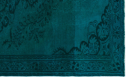 Load image 1 in gallery view. Teal rug with a dark, distressed floral medallion pattern and a decorative border.
