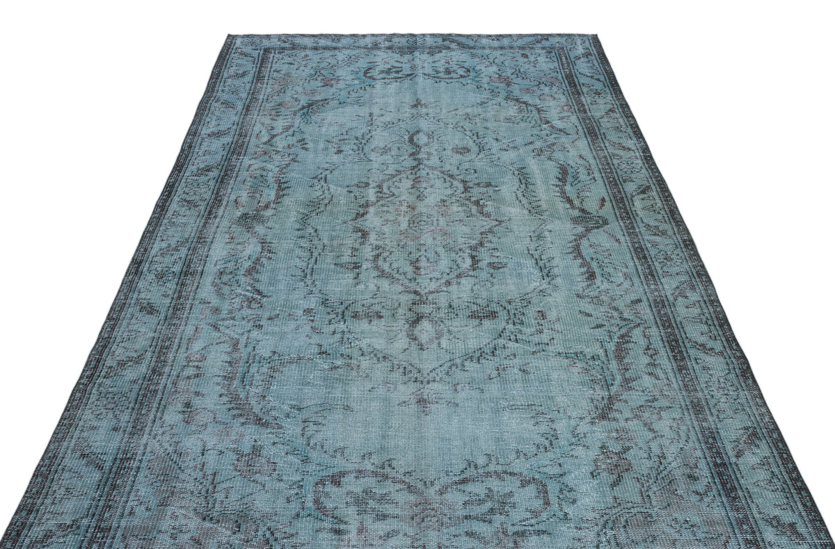 Distressed teal and charcoal rug with a traditional central medallion and ornate border pattern on a white background.