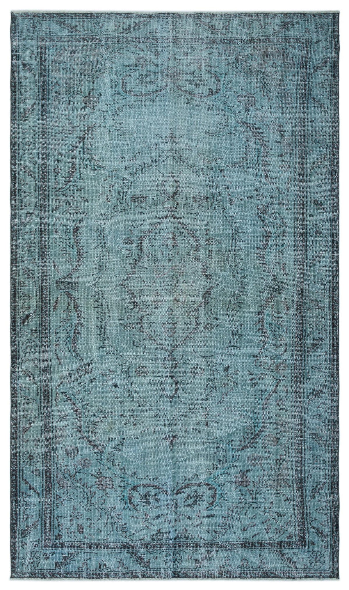 Distressed teal and charcoal rug with a traditional central medallion and ornate floral border.