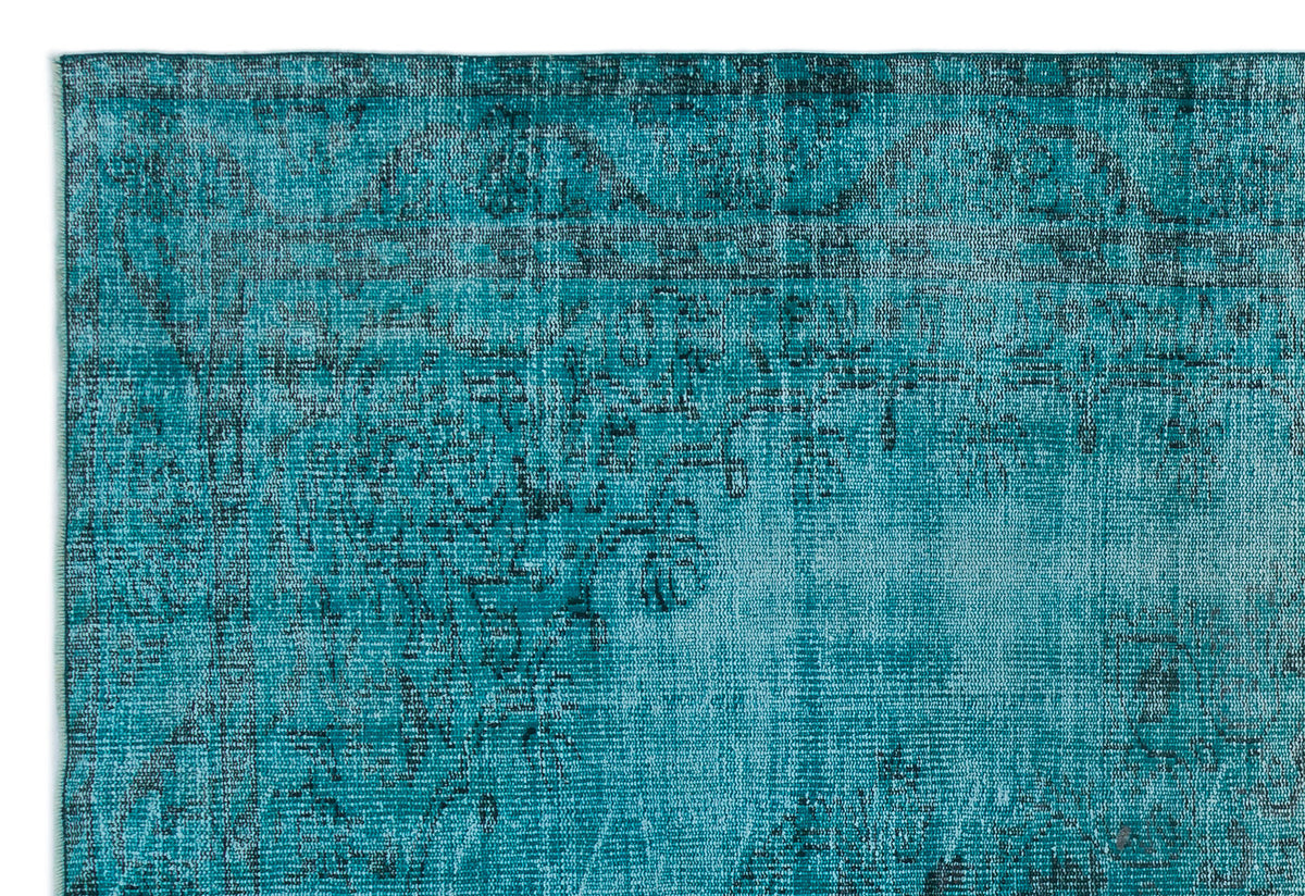 Teal and black distressed rug with a faded traditional medallion pattern.