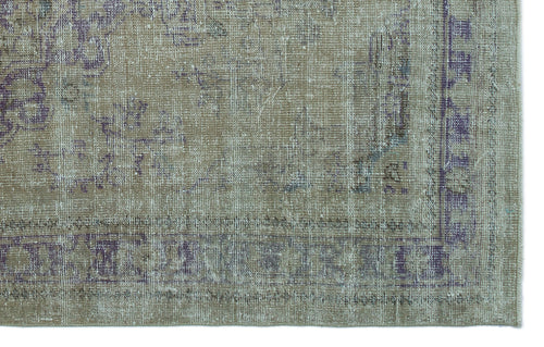 Load image 1 in gallery view. Distressed beige and purple vintage-style rug with a faded traditional medallion pattern and a bordered edge.