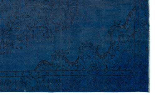 Load image 1 in gallery view. Deep blue rug with a subtle, dark-toned traditional floral border and medallion pattern.