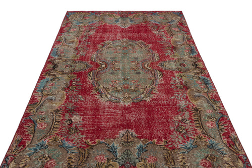 Load image 1 in gallery view. Distressed red Persian-style rug with a central sage green medallion and intricate floral border patterns.