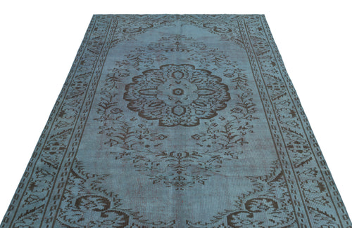 Load image 1 in gallery view. Blue and charcoal distressed rug with a central floral medallion and ornate border pattern on a white background.