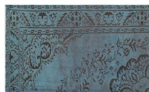 Load image 1 in gallery view. Teal rug with a dark brown distressed floral medallion pattern and a geometric border.