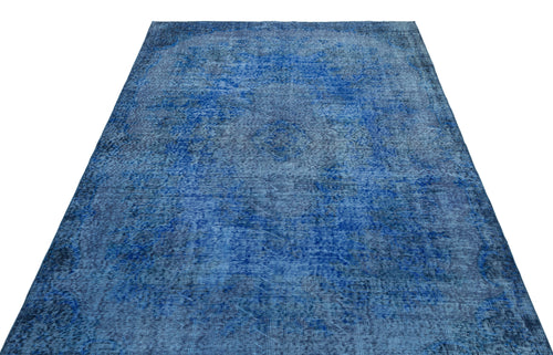 Load image 1 in gallery view. Deep blue distressed area rug with a faded traditional medallion pattern on a white background.