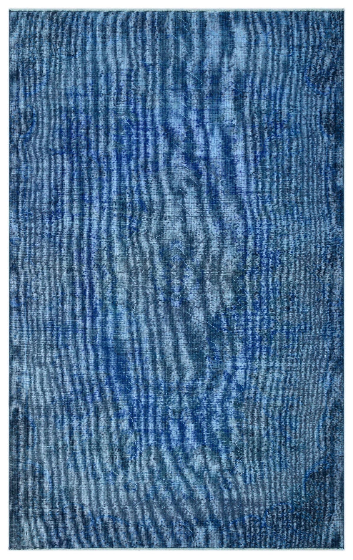 Monochromatic blue area rug with a distressed, vintage-inspired overdyed pattern.