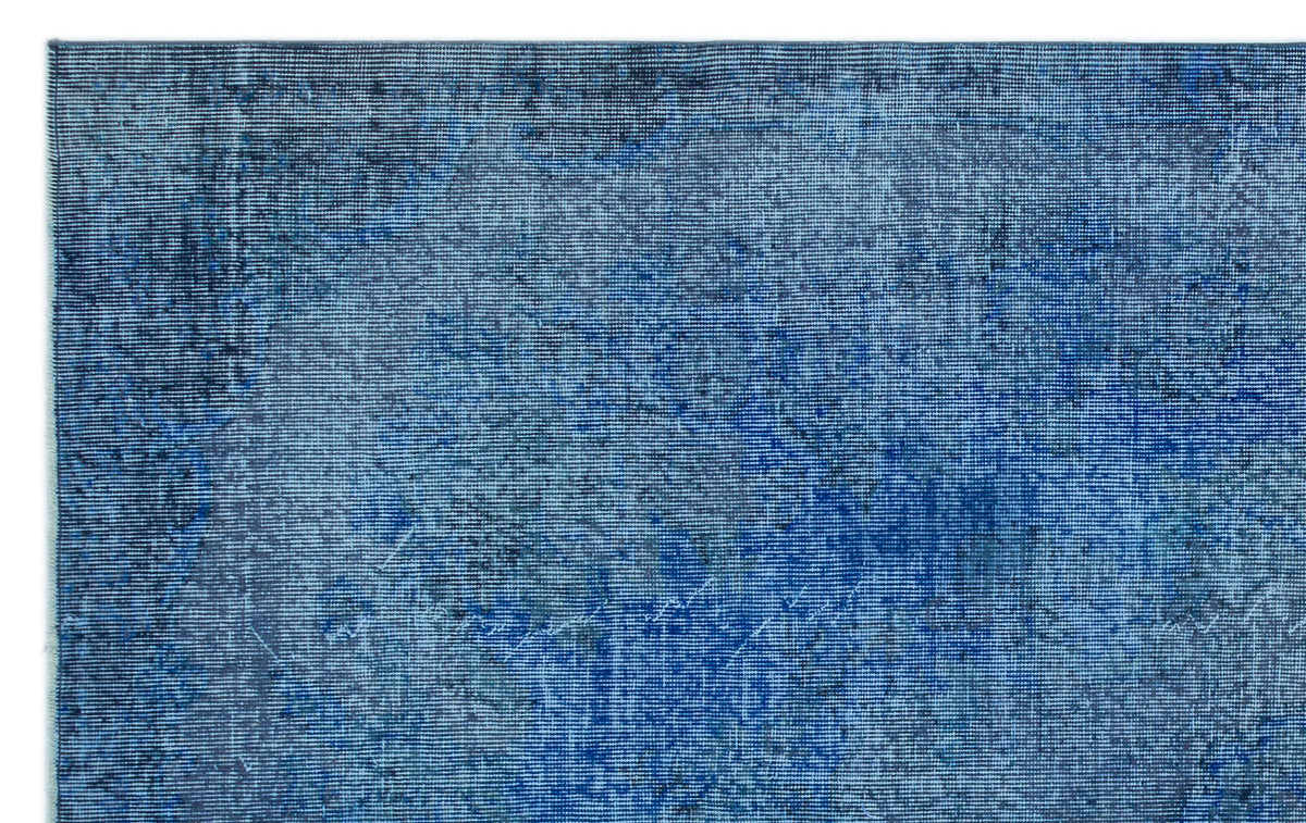 Deep blue distressed rug with a faded, vintage-inspired texture and subtle tonal variations.