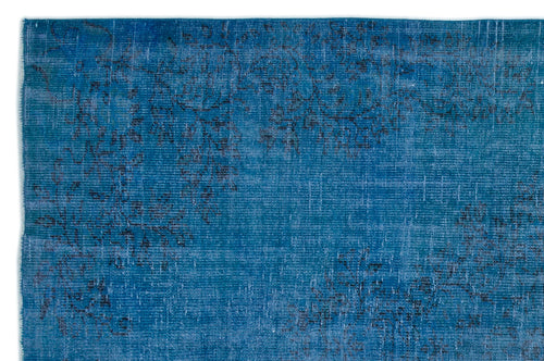 Load image 1 in gallery view. Deep blue distressed rug with a faded, dark charcoal floral pattern.