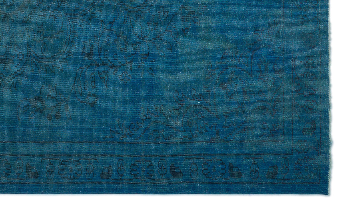 Deep blue rug with a subtle, dark-toned floral medallion pattern and a detailed border.