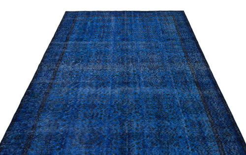 Load image 1 in gallery view. Deep blue vintage-style rug with a distressed, intricate floral medallion pattern and a dark border.