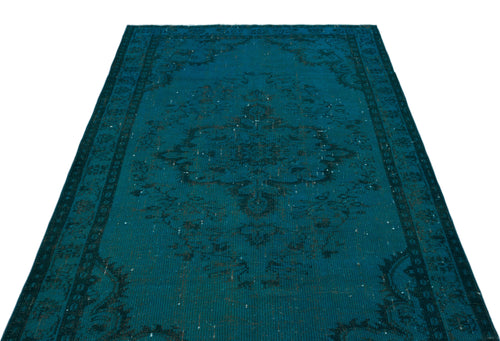Load image 1 in gallery view. Teal distressed area rug with a dark central medallion and traditional border pattern on a white background.