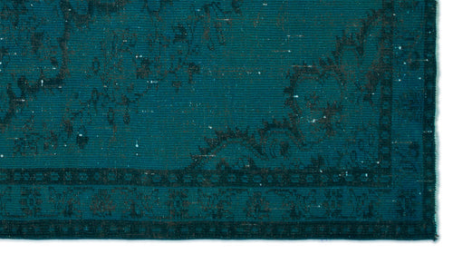 Load image 1 in gallery view. Teal and black distressed rug with a traditional ornate border and faded floral medallion pattern.