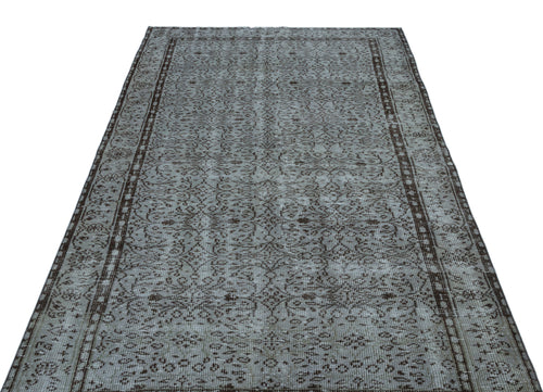 Load image 1 in gallery view. Grey and dark brown distressed rug with an intricate traditional floral pattern and a bordered edge.
