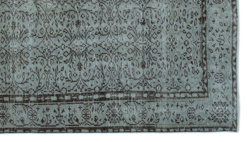Load image 1 in gallery view. Distressed sage green and dark brown rug with a traditional floral medallion pattern and a decorative border.